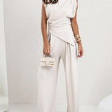 Elegancki komplet z asymetryczną bluzką i szerokimi spodniami