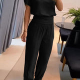 Elegancki komplet z bluzką V-neck i luźnymi spodniami z wysoką talią