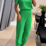 Elegancki komplet z bluzką V-neck i luźnymi spodniami z wysoką talią