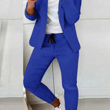 Czarny elegancki komplet z taliowaną marynarką i dopasowanymi spodniami ze sznurkiem